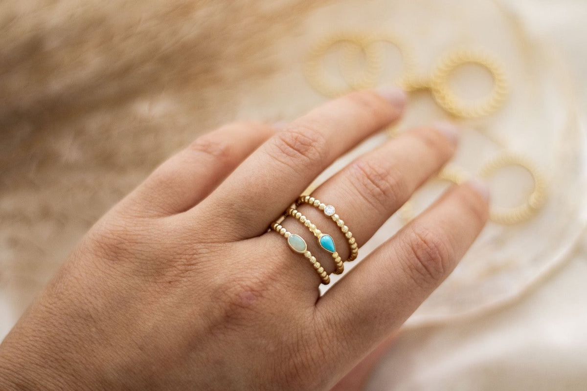 Kugelring aus 585 Gelbgold mit Türkis Edelstein in Tropfenform